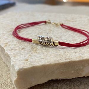 Red Kabbalah string bracelet with a gold-filled Hebrew Traveler’s Prayer scroll